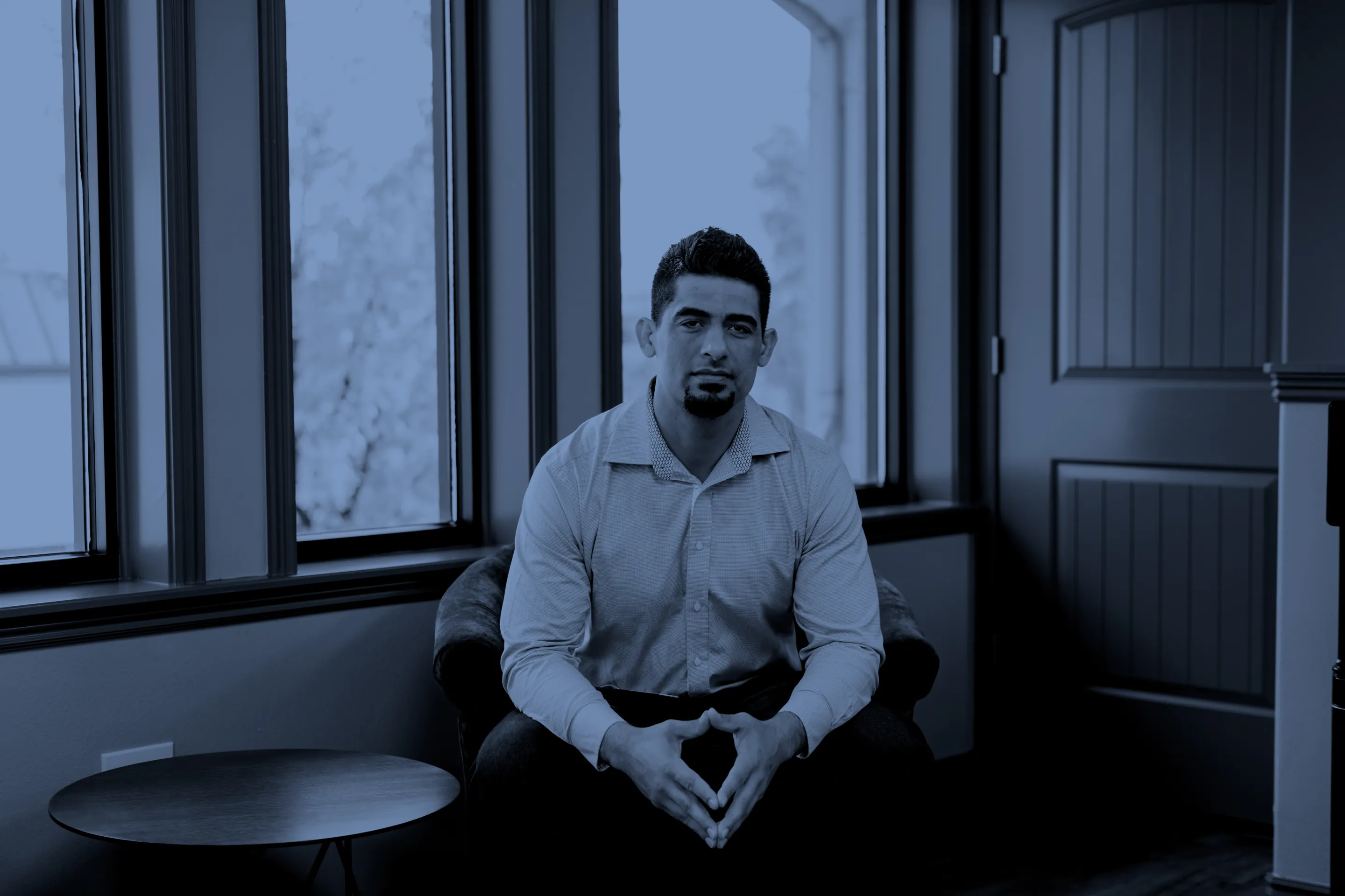 Skye Grossman seated in an armchair by tall windows